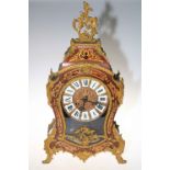 Ornate gilt metal French boule clock with decorative finial, 59cm high.