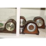 Four mantel clocks.