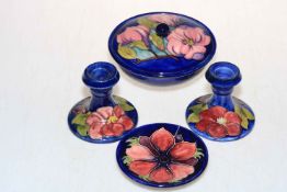 Moorcroft Anemone on blue ground pair of candle holders and dish,