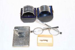 Silver card case, two silver napkin rings, silver rimmed spectacles and small dagger style brooch.
