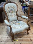 Victorian walnut spoon back open armchair in needlework fabric.