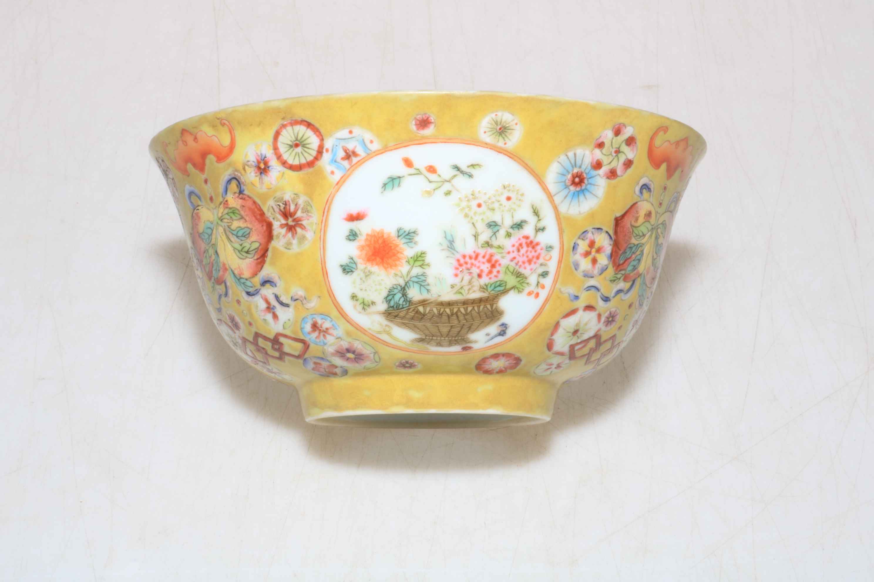 Small Chinese porcelain bowl with floral design on yellow ground, Qianlong mark to base,