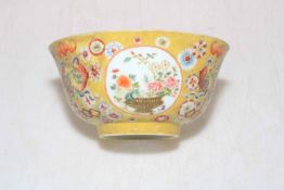 Small Chinese porcelain bowl with floral design on yellow ground, Qianlong mark to base,