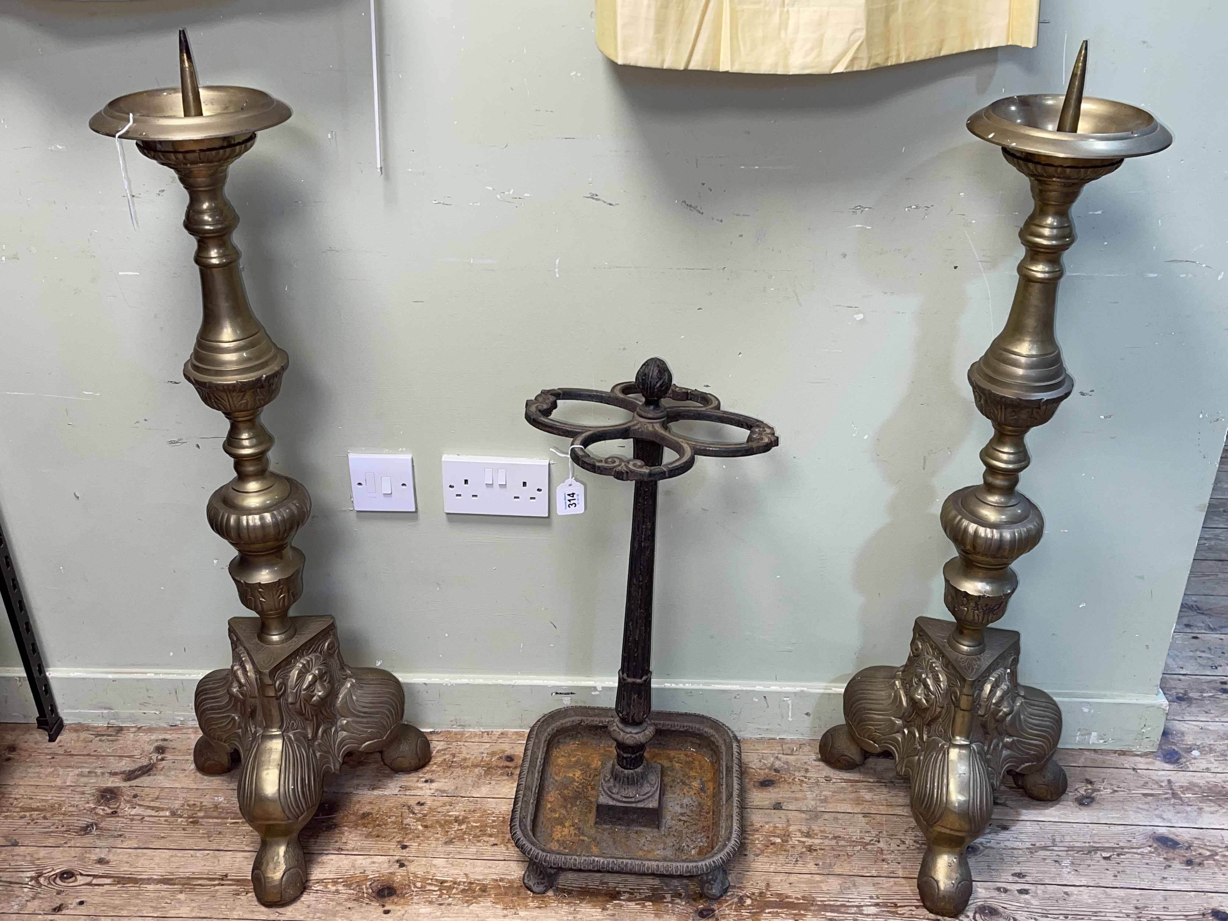 Pair large brass triform pricket sticks, 107cm.