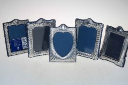 Collection of five embossed rectangular photograph frames.