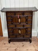 Oriental altar/side cabinet having three frieze drawers above four cupboard doors divided by two