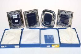 Set of four hallmarked sterling silver photograph frames, boxed.