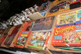 Seven boxes of vintage jigsaw puzzles.