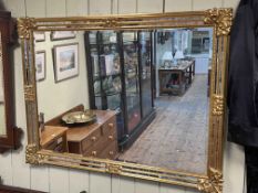 Rectangular gilt framed bevelled wall mirror, 89cm by 118cm.