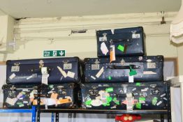 Collection of five Globe Trotter suitcases with travel stickers including Cunard.
