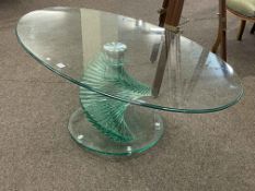 Contemporary oval glass coffee table on swirling pedestal base, 45cm by 120cm by 66cm.