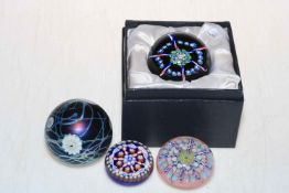 Four glass paperweights including boxed limited edition Ship's Wheel.