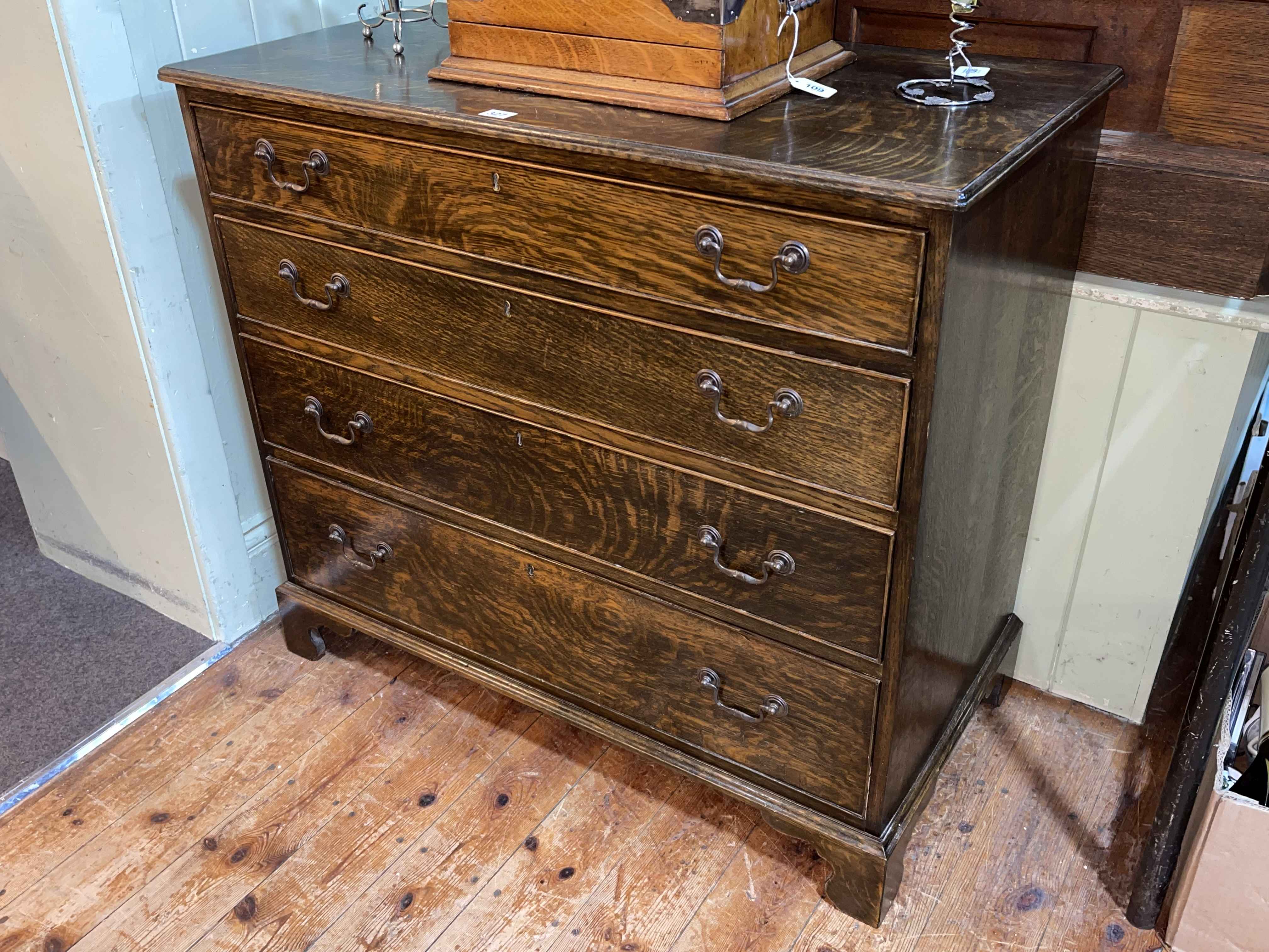 Georgian style oak chest of four long graduated drawers on bracket feet, 84cm by 94cm by 47.5cm.