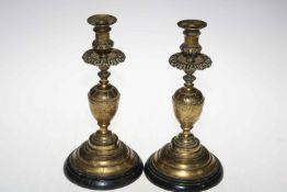 Pair of ornate engraved candlesticks.