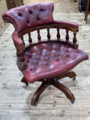 Red buttoned leather Captains style swivel desk chair.