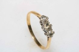 Three stone diamond ring set in 9 carat yellow gold, size T, boxed.