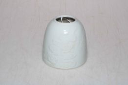 Chinese Celadon brush washer with raised floral decoration, six character mark to base, 8cm high.