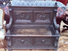 Victorian carved oak hall box bench having double carved figural panel back and lion arms,