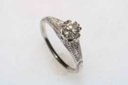 Platinum and diamond half carat diamond ring with engraved shoulders set with small diamonds,