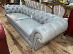 Grey deep buttoned and studded leather three seater Chesterfield settee, 246cm in length.