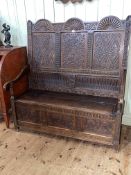 19th Century carved oak triple arched panel back box settle, 143cm by 136.5cm by 71cm.