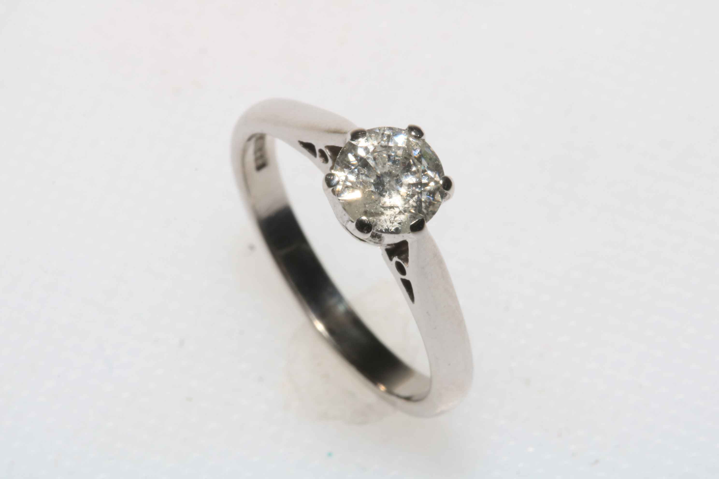 18 carat white gold and diamond solitaire ring, the 63 point diamond colour H and clarity Si1,