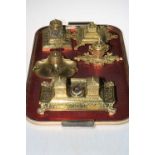 Five ornate brass inkstands.