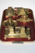 Five ornate brass inkstands.