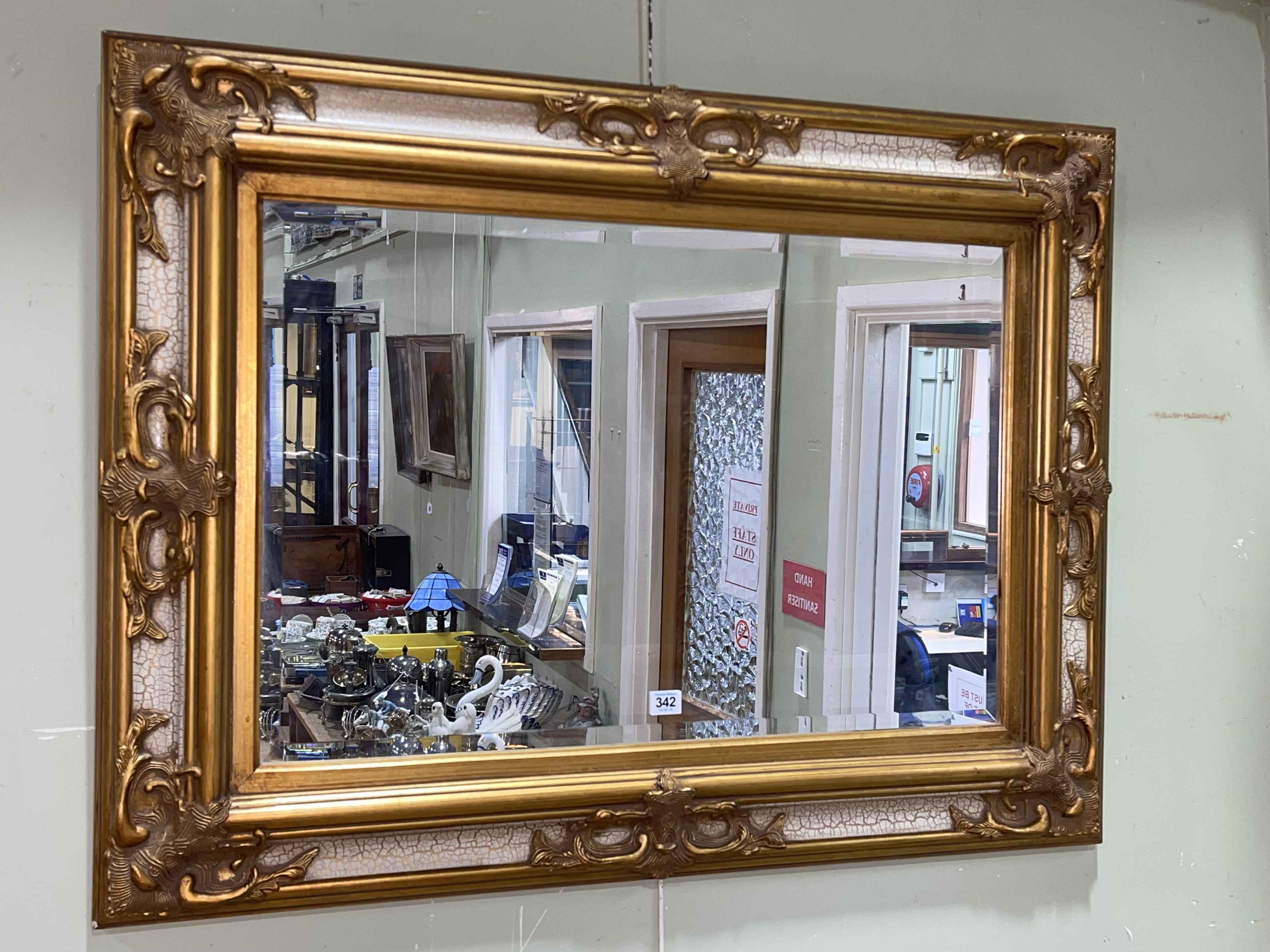 Gilt and part painted rectangular bevelled wall mirror, 76cm by 101.5cm.
