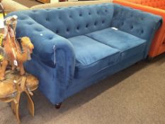 Contemporary two seater Chesterfield settee in blue buttoned fabric.