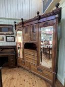 Victorian carved mahogany gents combination wardrobe, 242cm by 197cm by 64cm.