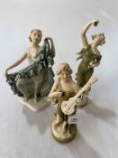 Three Royal Dux figurines.