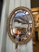 Oval gilt framed marginal mirror, 67.5cm by 53cm.
