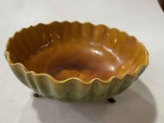 Linthorpe bowl with fluted rim and on three small moulded feet, no. 1867, 24cm diameter.