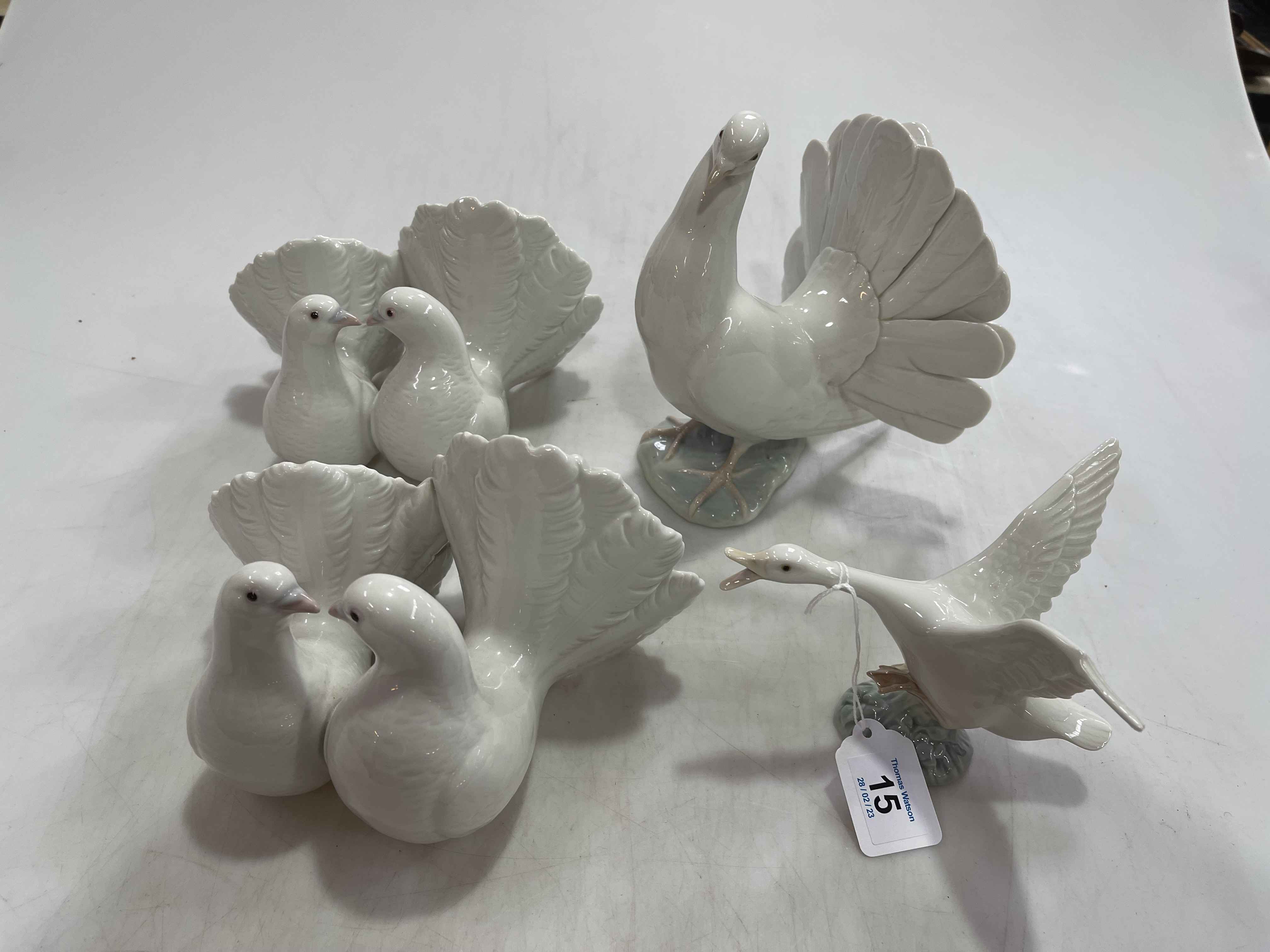 Lladro: three dove pieces and goose taking flight, with three boxes.