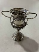 Silver two handle trophy cup with embossed decoration and vacant cartouche, 14.5cm, Sheffield 1926.
