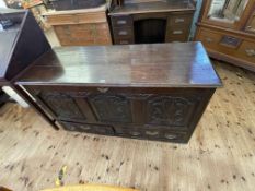 Antique carved oak triple panel front kist having two base drawers, 74.5cm by 140cm by 55cm.