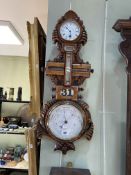 Carved oak combination barometer-clock-calendar.