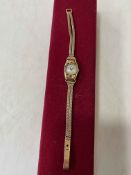 Ladies 18 carat gold wristwatch with enamel decoration and cabachon winder,
