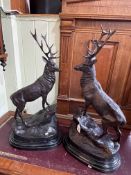 Pair of impressive bronze models of stags standing on rocky outcrops on marble bases, 74cm high.