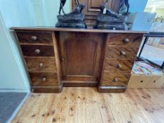 Victorian mahogany eight drawer pedestal desk having kneehole cupboard door, 76cm by 122cm by 52cm.