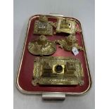 Collection of five ornate brass inkstands.