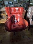 Vintage red buttoned swivel egg chair.