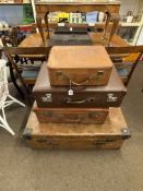 Large vintage leather trunk and three vintage suitcases.