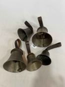 Set of five vintage hand bells with leather strap handles.