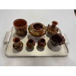 Linthorpe Pottery: seven pieces of floral decoration on brown ground.