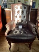 Brown buttoned leather and studded armchair.
