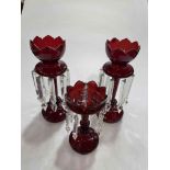 Three Victorian red glass lustres.