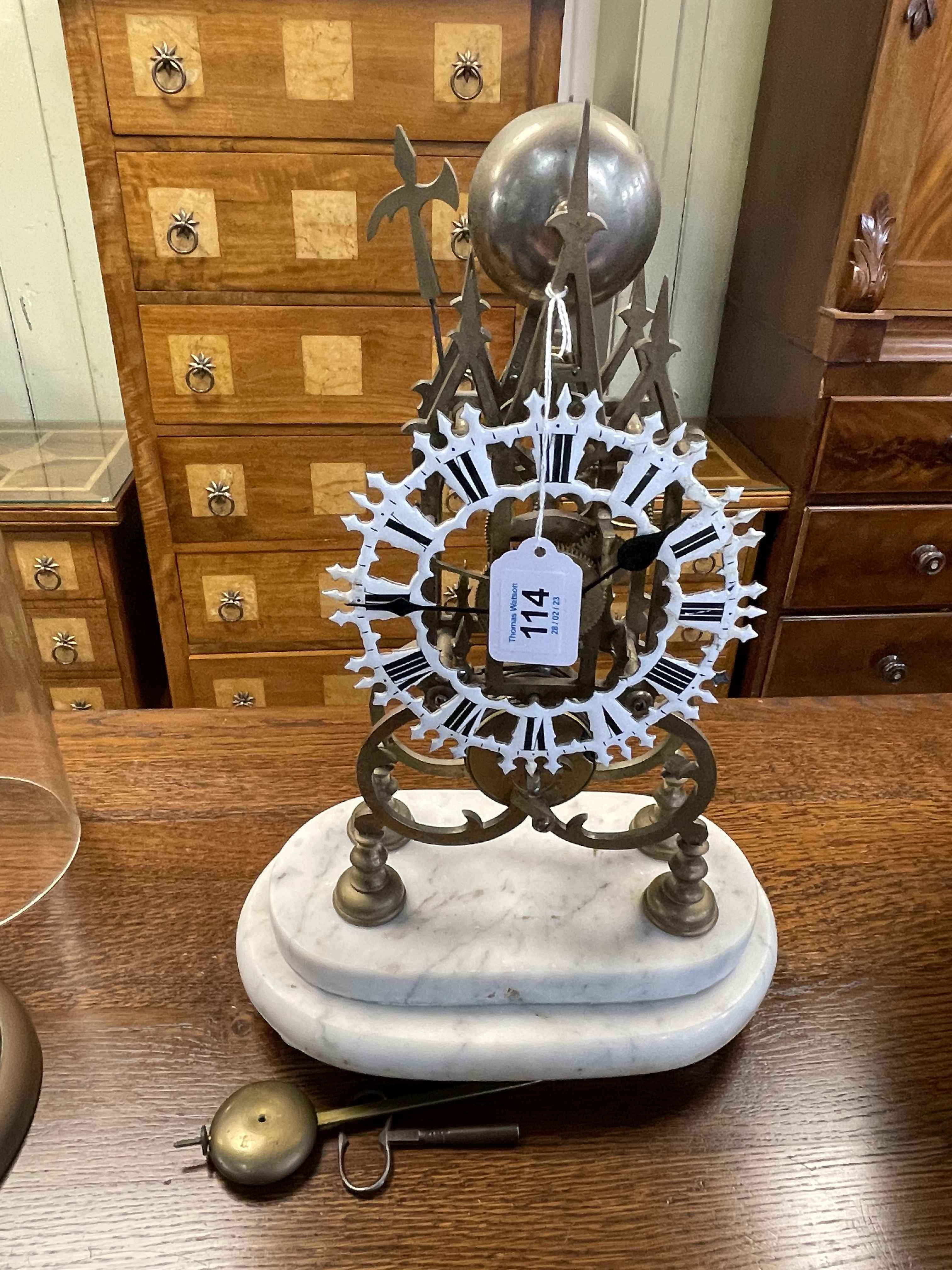 Victorian cast metal skeleton clock on stone plinth, 41cm.