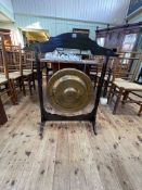 Edwardian beaten brass dinner gong, beater and stand, 99.5cm by 85cm.